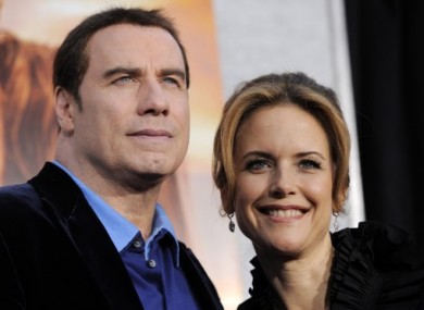 Travolta pictured with his wife Kelly Preston last March.