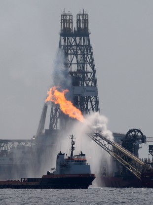 A work boat operates near the Helix Producer in the area of the Deepwater Horizon oil spill on the Gulf of Mexico in July.