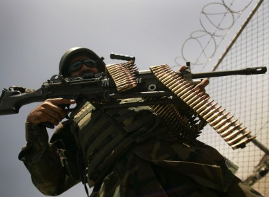 An Afghan army soldier stands guard at a security check point at a military base in Herat, west of Kabul, Afghanistan.