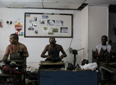 Workers repair shoes in the 'La Habanera' state-owned workshop in Havana, Cuba yseterday.