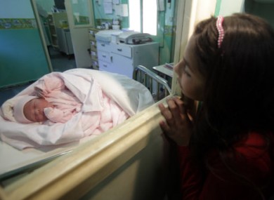Newborn Esperanza Ticona is watched by her cousin in hospital some 70km from the mine.