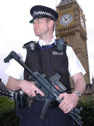 A genuine armed police officer in official uniform on patrol in London.