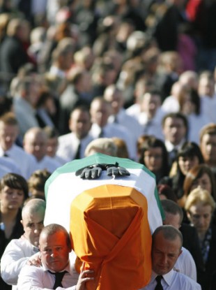 The coffin of Irish Republican John Brady is carried during his funeral in Strabane, Northern Ireland, Thursday Oct. 8,