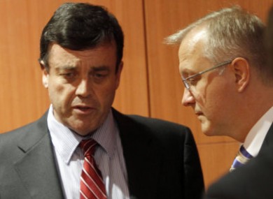 Minister Brian Lenihan speaks to Commissioner Ollie Rehn at an EU meeting in September.