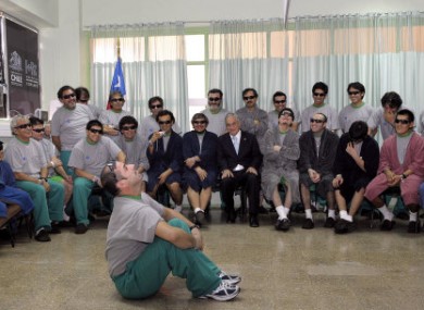 Miner Mario Sepulveda sits on the floor surrounded by his colleagues at the hospital where the miners are being treated.