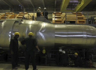Workers in a part of the electricity generating plant of the Bushehr nuclear power plant, just outside the southern city of Bushehr, Iran, today.