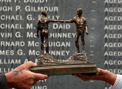 Relatives of the victims of Bloody Sunday hold a statue presented to them by leaders of Northern Ireland's protestant churches.