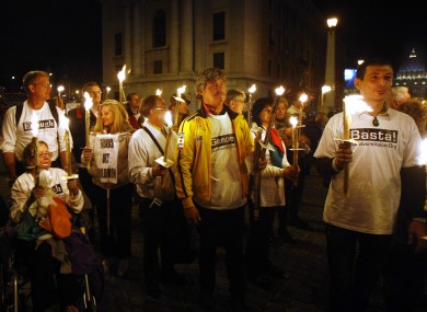 Demonstrators hold candles during a protest near St. Peter's Square last night after police stopped them from marching into the Vatican.