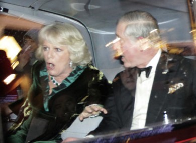 Prince Charles and Camilla react as their car comes under attack from protesters last night.