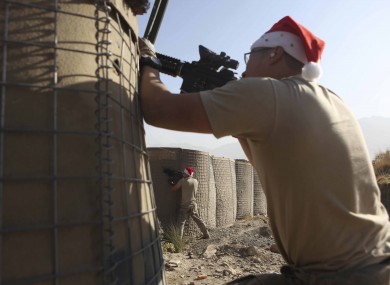 An American soldier returns fires after a sudden attack by Taliban on Combat Out Post Badel in eastern Afghanistan near the Pakistan border earlier today.
