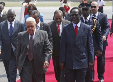 Cape Verde President Pedro Pires, left, walks with Ivory Coast Prime Minister Ake N'gbo on arrival at the airport in Abidjan, yesterday.