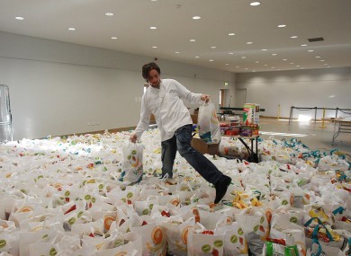 A volunteer fills goodie bags for a Christmas party for the homeless last year.