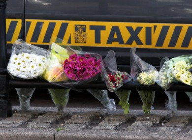 Flowers left at the taxi rank where Derrick Bird shot and killed a driver in June 2010.