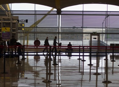 Passengers walk with luggage trolleys at Barajas Airport in Madrid during an air traffic controllers' strike in December.