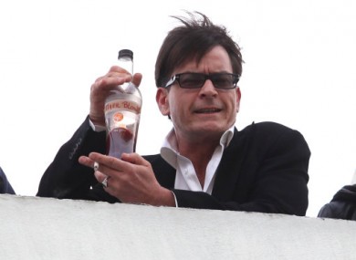 Charlie Sheen holds a bottle of 'Tigerblood' on a Beverly Hills rooftop.