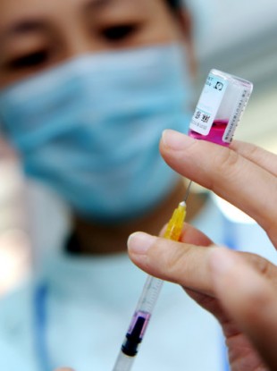 File photo of a medical worker preparing an injection of a measles vaccine.