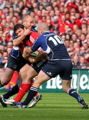 Leinster's Chris Whitaker and Felipe Contepomi tackle David Wallace of Munster.