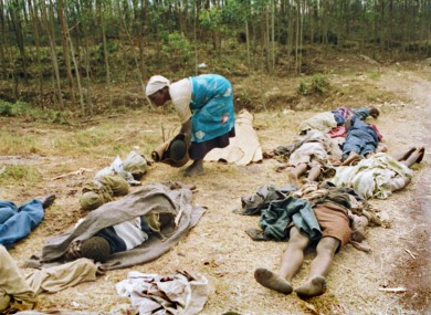 A Rwanda Hutu refugee woman places her baby among the dead for burial at the Kibumba refugee camp, Rwanda, in April 1994.