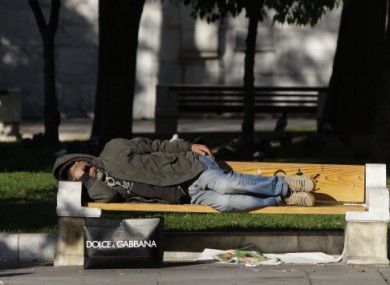 File photo of an unidentified homeless man sleeping on a park bench.