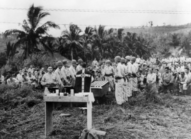 Captain FX Shannon officiating at a memorial service for fallen US troops in the Philippines on 3 February, 1945.