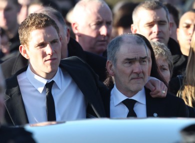 Husband John and father Mickey Harte walk behind the hearse carrying the remains of Michaela McAreavey to St Malachys Church near Ballygawley in Co Tyrone.