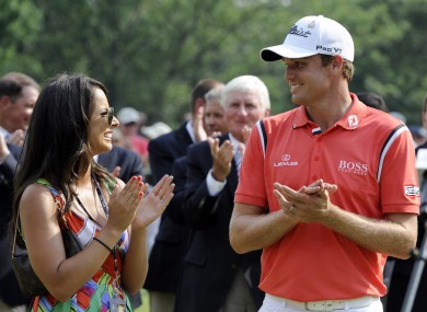 Nick Watney and his wife, Amber, applaud during ceremonies after Watney won the AT&T National at Aronimink Golf Club yesterday.