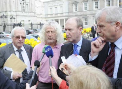 Mick Wallace usually stands out among the suit-and-tie brigade - but may soon be forced to don a formal jacket to do his job.