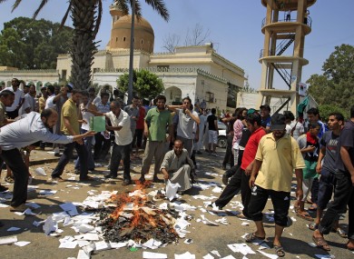 Rebel supporters burn Green books in the main square of the Qasr Bin Ghashir district in Tripoli