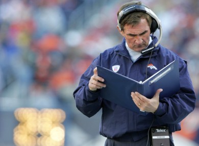 Mike Shanahan: deciphering his own handwriting.