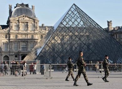 Soldiers patrol in front of the Louvre in Paris after al-Qaeda threatened to target France in October 2010