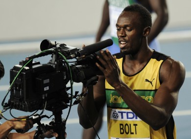 Usain Bolt celebrates into the camera after winning his 100m heat.