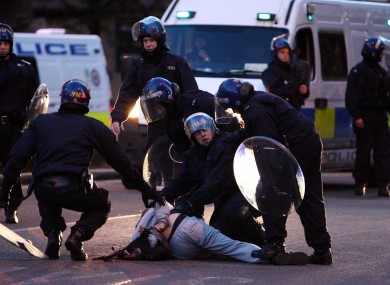 Police detain a man near the site of looting in an electronics store near New St Station, Birmingham, last night