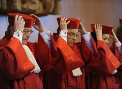 File photo: Members of Germany's Constitutional Court in Karlsruhe put on their hats as they prepare for a day in court.