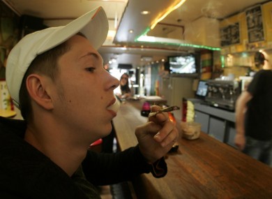 A coffee shop customer smoking a joint