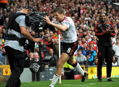 Liverpool's Steven Gerrard hugs a TV camera at Old Trafford in 2010. An ECJ ruling could have major implications for the lucrative TV rights that propel the Premier League.