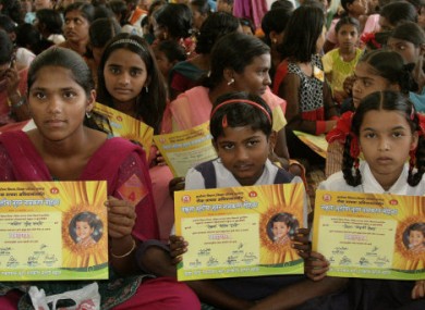 Girls hold certificates stating their new official names during a renaming ceremony in Satara, India,