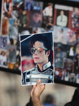File photo: A fan holds a photograph of the late Michael Jackson.