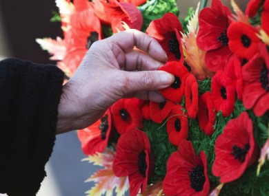 Touching the past: a woman meditates on Remembrance Day in Canada last year.