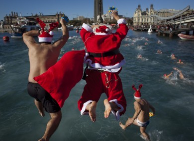 Athletes dressed as Santa Claus jump on the Mediterraean sea as they take part in the Copa Nadal held annually in Barcelona.