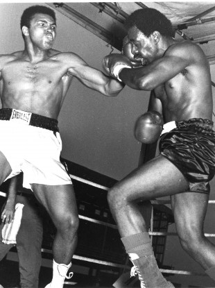 Muhammad Ali slams a left hook into Al