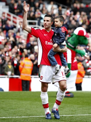 New signing? Robin and Shaqeel van Persie greet the Emirates crowd.