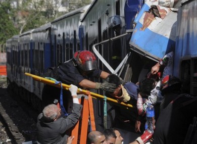 Firemen rescue injured passengers from the crashed train in Buenos Aires.