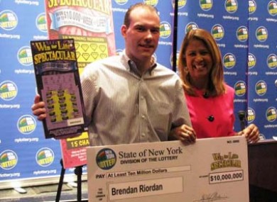 Brendan Riordan collects his cheque for $10 million, from NY Lottery's Youlanda Vega.