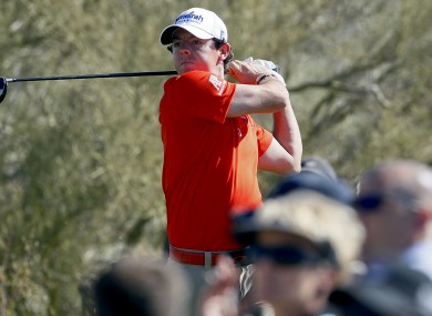 Rory McIlroy tees off on the 14th hole while playing South Korea's Bae Sang-moon.