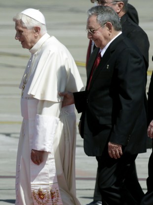 Pope Benedict XVI walks with Cuba's President Raul Castro