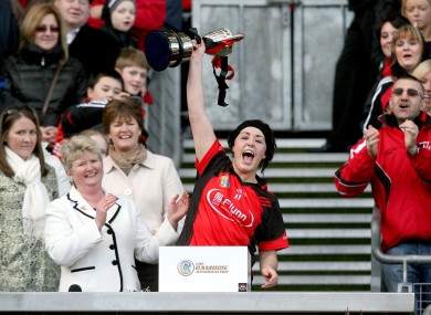 Oulart-the-Ballagh's Una Leacy lifts the trophy.