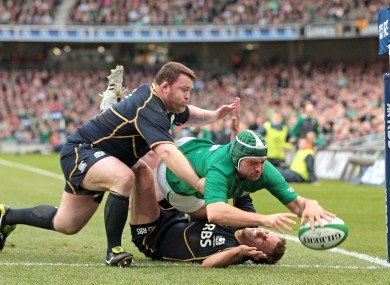 Ireland's Rory Best scores a try despite the attentions of Mike Blair and Allan Jacobsen.