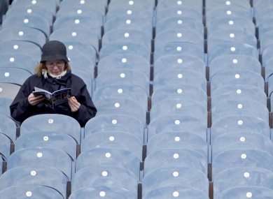 A spectator studies her programme before the Dublin v Cork game yesterday.