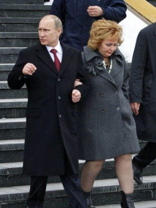 Putin leaves a polling station earlier today with his wife Lyudmila.
