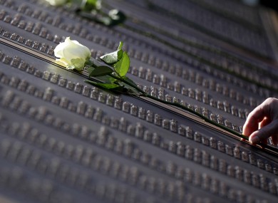 An unidentified woman places a rose on the Titanic Memorial Plaque during the service at Belfast City Hall